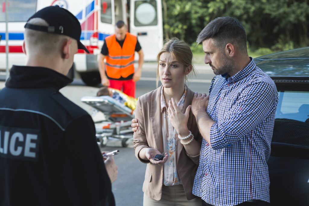 Bystanders describing the scene of a tractor trailer accident to the police officer