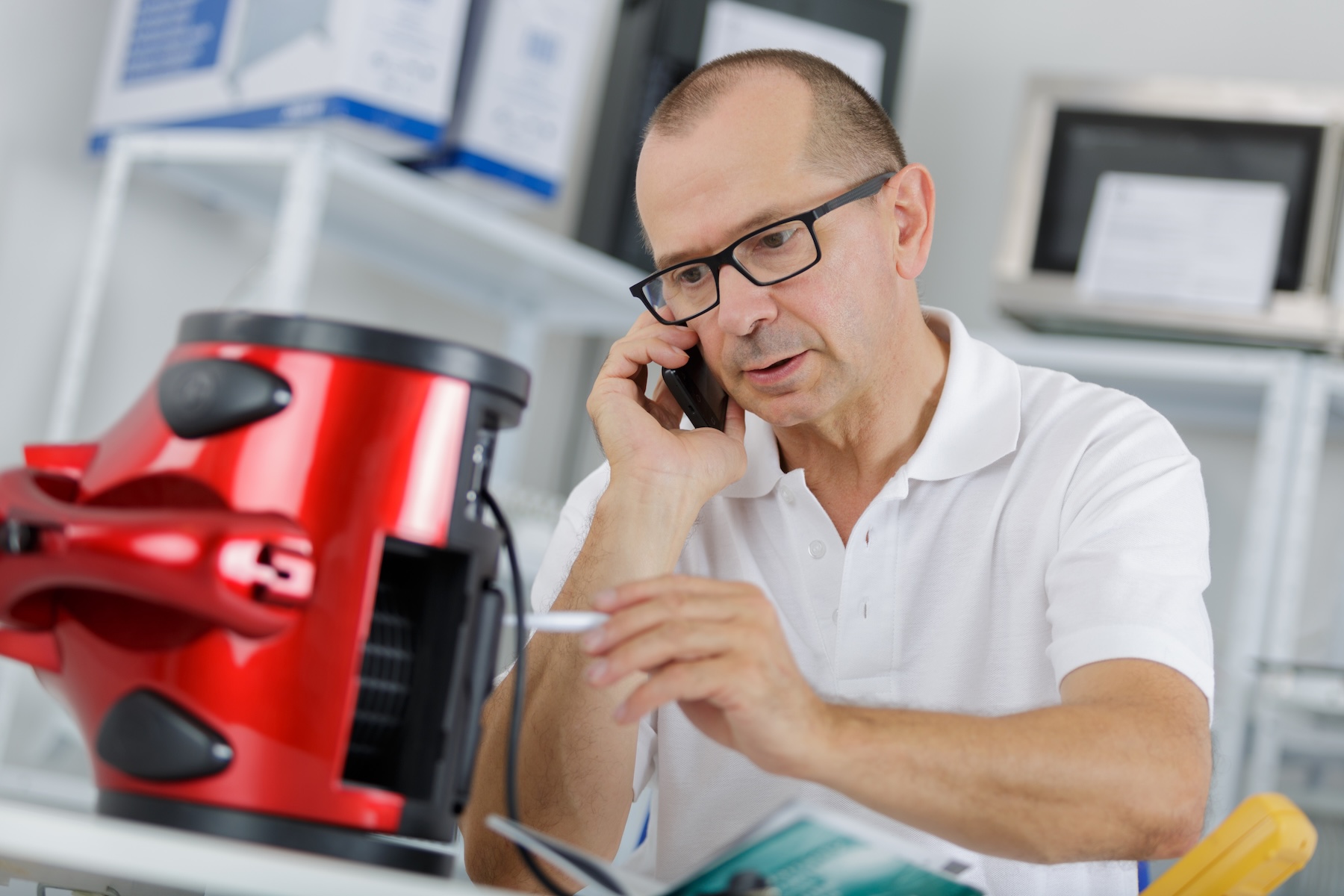 Man on phone with customer service asking for a machine's part