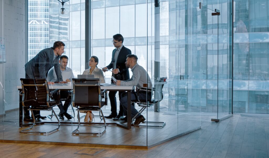 Young business people holding a discusison in modern office building