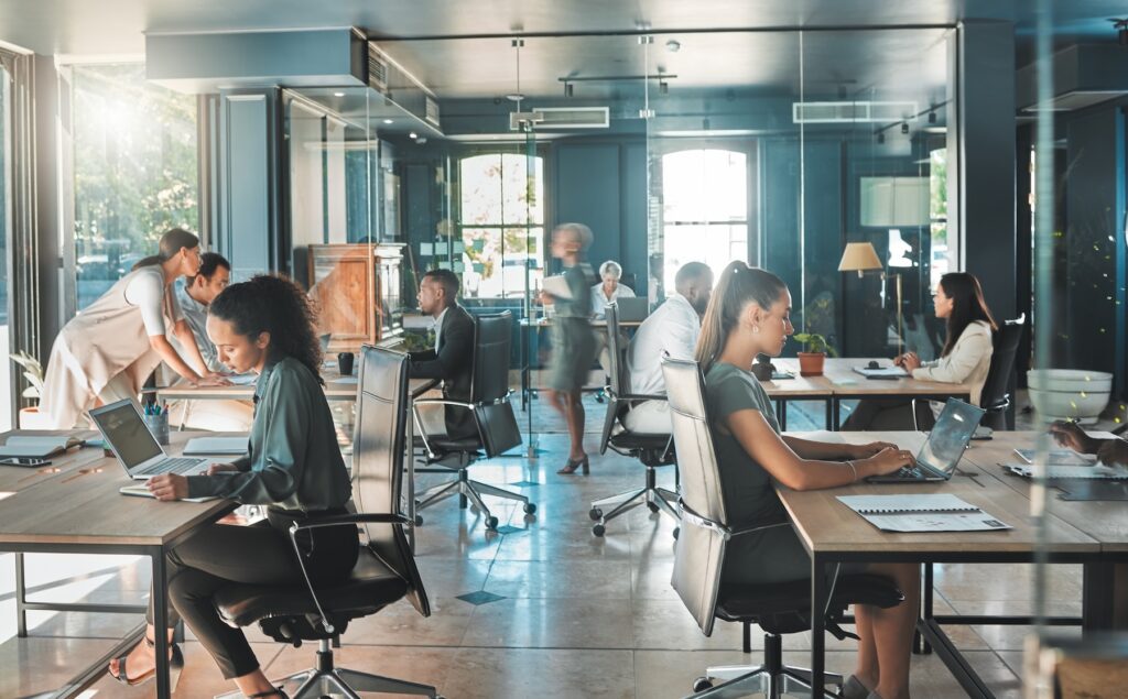 Corporate business people working in busy marketing office space