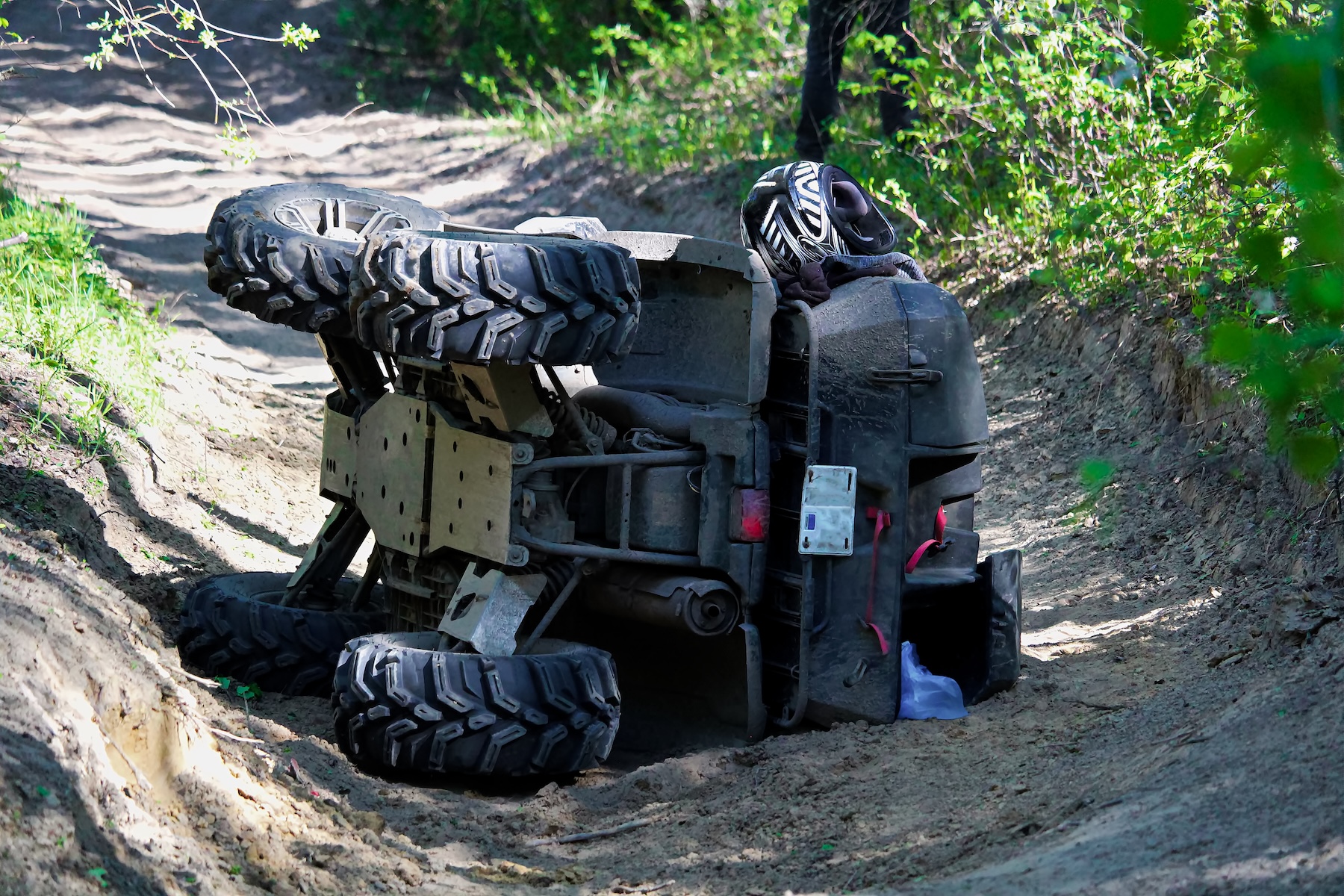 ATV on its side in ditch after flipping